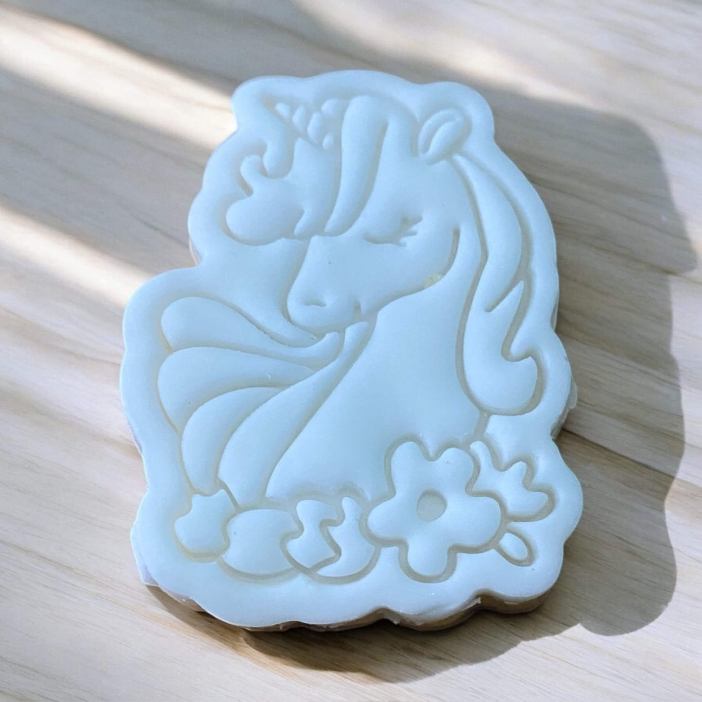Unicorn Head with Flowers Paint Your Own Cookie – unicorn head-shaped iced biscuit decorated with flowers, with edible paint palette and brush, fun and creative kids’ baking activity or party treat.