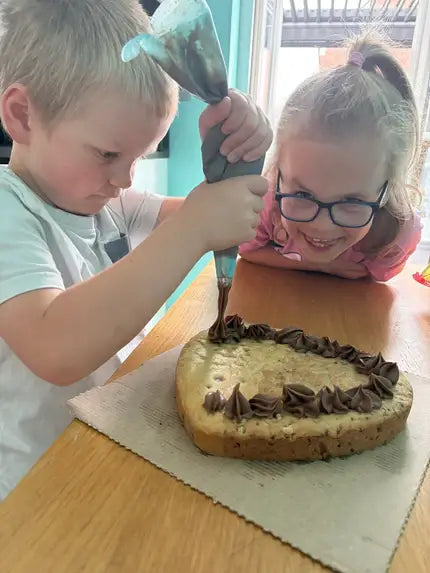 Children baking a Father’s Day Celebration Cookie using Bake My Day cookie baking mix – fun and easy bake-at-home activity for kids, perfect for creating personalised Father’s Day treats, family baking, and creative holiday recipes.