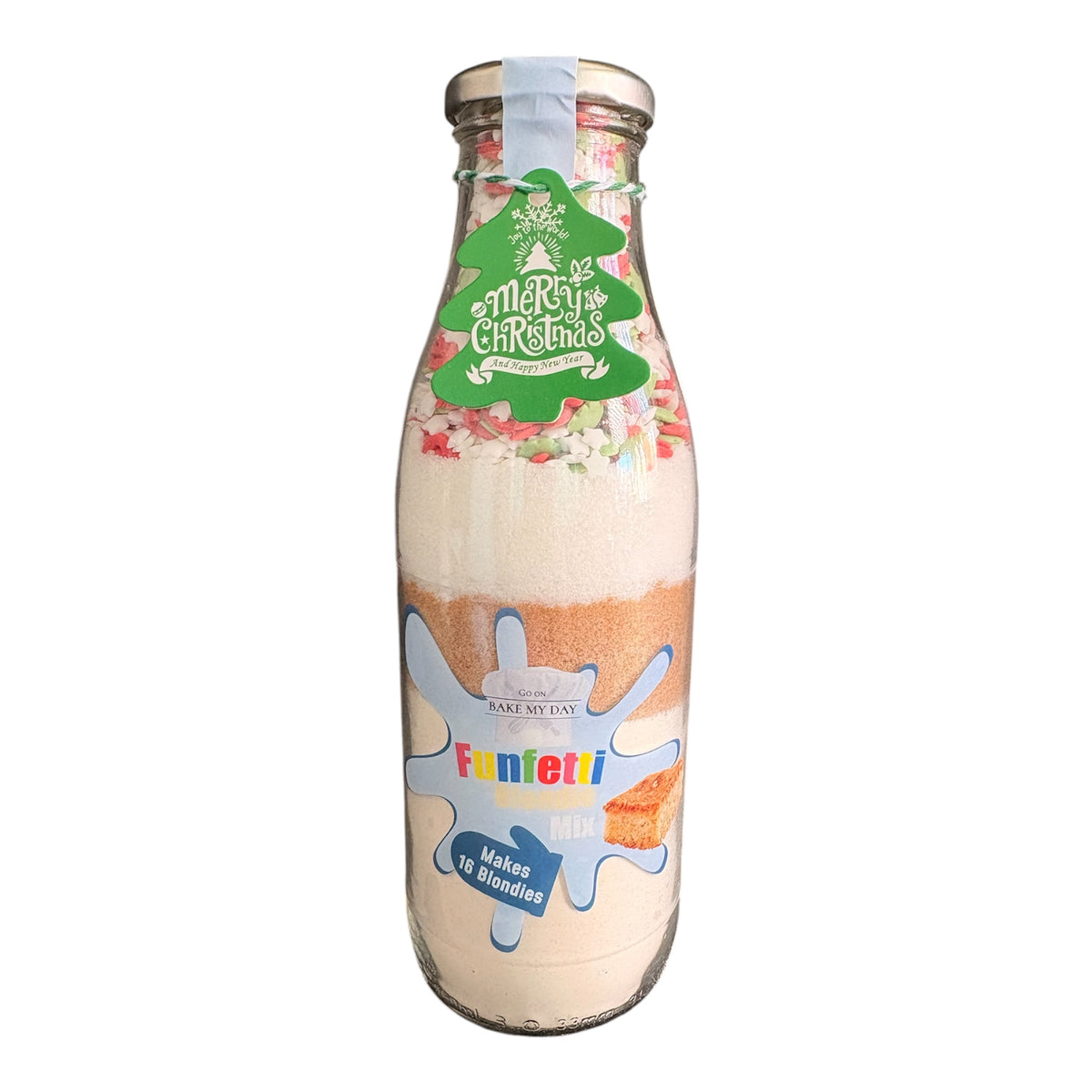 A glass milk bottle filled with layered Funfetti Christmas mix and topped with a green 'Merry Christmas' label, isolated on a white background.