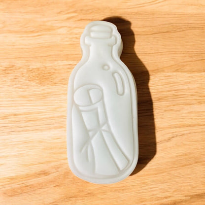 Message Bottle Paint Your Own Cookie – bottle-shaped iced biscuit with edible paint palette and brush, creative kids’ baking activity or pirate-themed party treat.