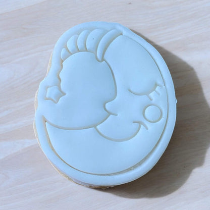 Moon Paint Your Own Cookie – crescent moon-shaped iced biscuit with edible paint palette and brush, creative kids’ baking activity or space-themed party treat.