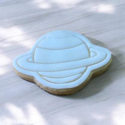 Planet Paint Your Own Cookie – planet-shaped iced biscuit with edible paint palette and brush, fun and creative kids’ baking activity or space-themed party treat.