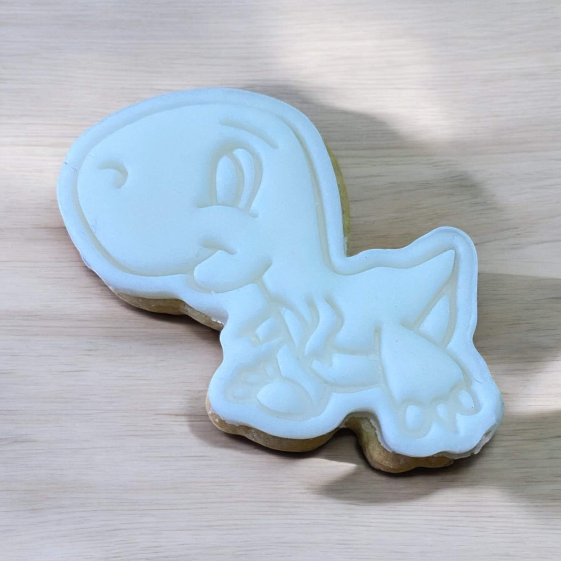 Raptor Paint Your Own Cookie – dinosaur shaped iced biscuit with edible paint palette and brush, fun and creative kids’ baking activity or party treat.
