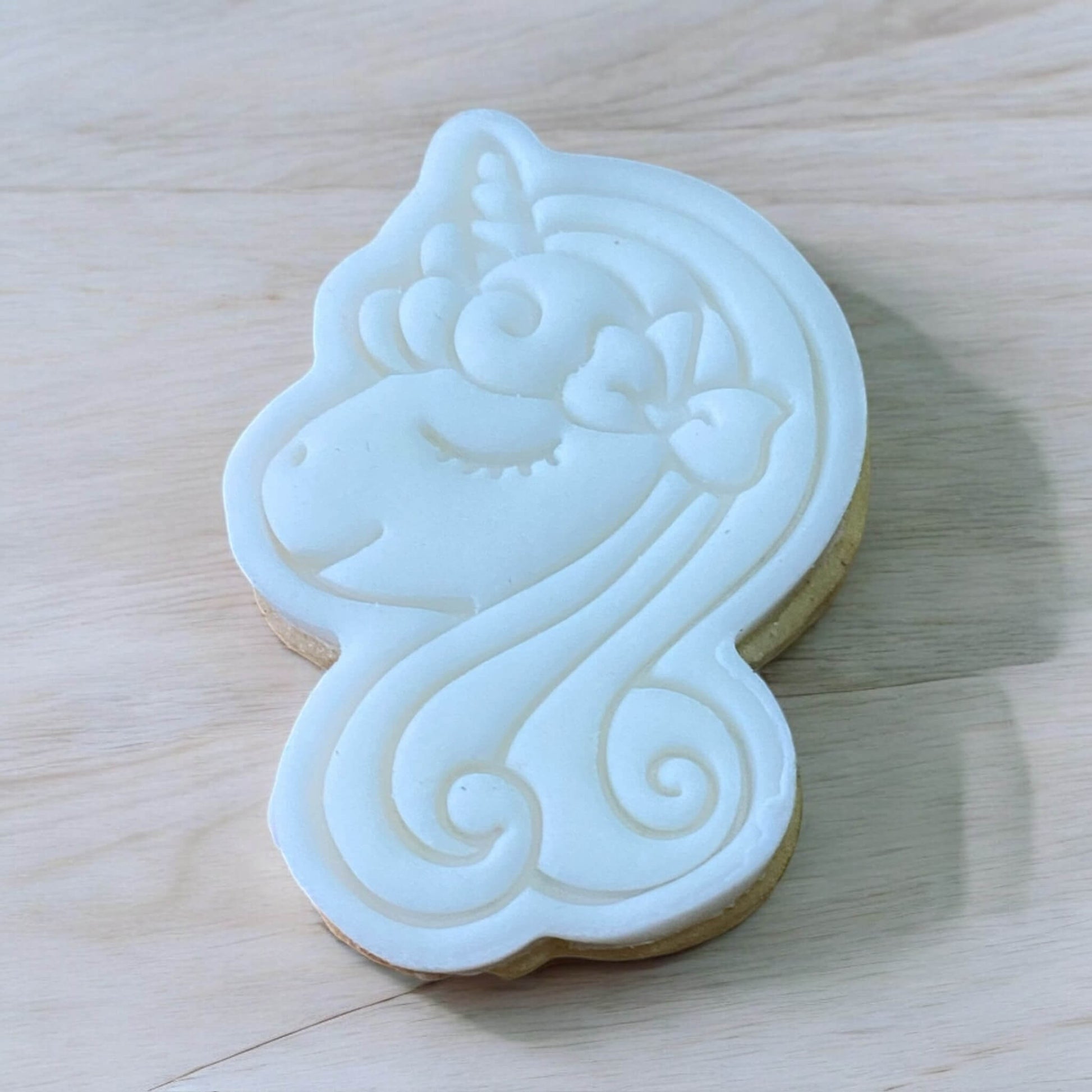 Unicorn Head Paint Your Own Cookie – unicorn head-shaped iced biscuit with edible paint palette and brush, magical and creative kids’ baking activity or party treat.