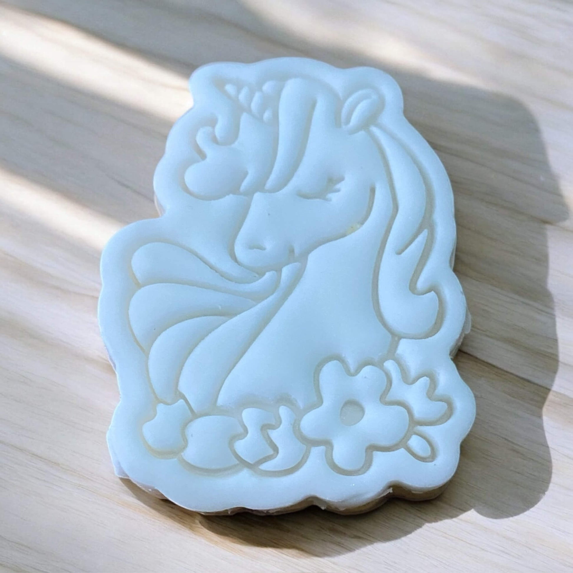 Unicorn Head with Flowers Paint Your Own Cookie – unicorn head-shaped iced biscuit decorated with flowers, with edible paint palette and brush, fun and creative kids’ baking activity or party treat.